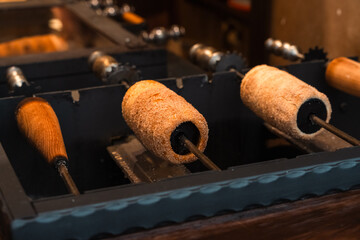 Traditional Trdelník Pastry Cooking on Grill in Central Europe