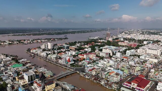 My Tho City, Dong Thap, Mekong Delta, Vietnam: 4K Aerial Drone View of Riverside Residential Area, Traditional and Modern Houses, Boats Docked Along Bao Dinh Canal, Tien River or Mekong River