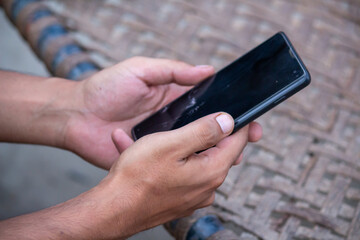 Close up of hands holding smartphone technology and lifestyle concept