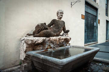 Ancient Stone Fountain with Sculpture in Rome Italy