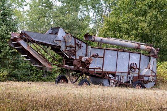 Antique threshing machine abandoned in a field