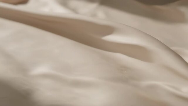 Close-up of Smooth Silk Fabric Flowing with Light