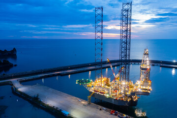 Aerial view of offshore jack up rig in a shipyard during sunset for oil and gas exploration and...
