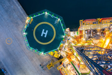 Aerial view of offshore jack up rig in a shipyard during sunset for oil and gas exploration and...