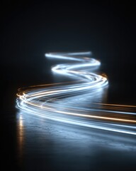 Abstract light trails curving through dark space