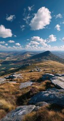 High angle view of a mountaintop landscape.  Vast vista of hills, rocks, and clouds