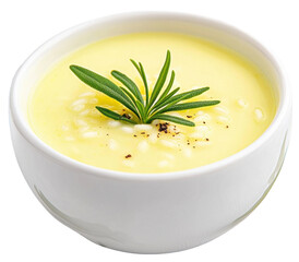 Creamy yellow soup garnished with rosemary in white bowl on transparent background