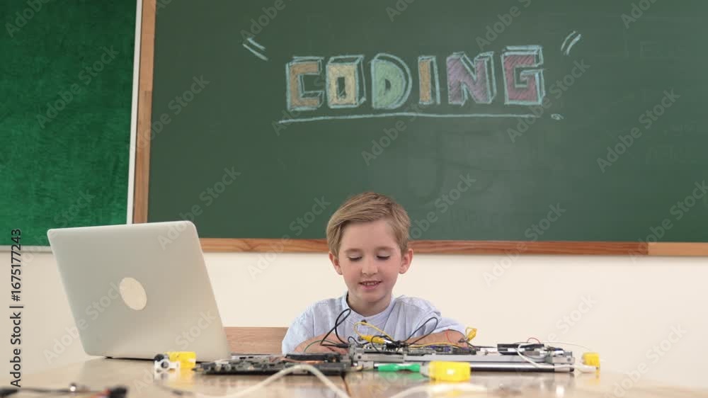 Poster student working on electronic board while sitting at stem class with blackboard. child fixing main b