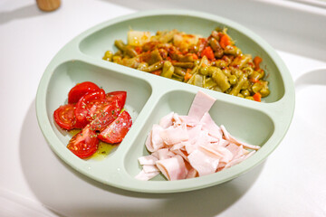 Baby led weaning meal with vegetables, tomato and turkey ham