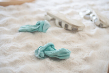 Soft blue socks and sandals on a cozy rug
