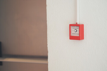 Fire alarm device mounted on wall in office interior
