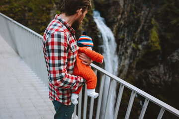 Family vacations travel in Norway dad and baby hiking together, sightseeing waterfall natural landmark on Gorsa bridge, active summer tour excursion outdoor