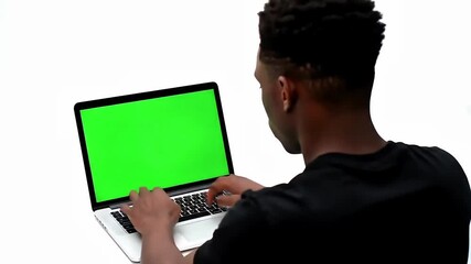 Young man typing on laptop with green screen display on white background - Powered by Adobe