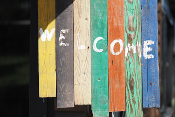 Colorful welcome sign made of reclaimed wood boards