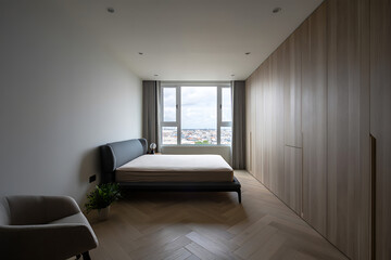 Modern Minimalist Bedroom Design Featuring a King Size Bed and Floor to Ceiling Wardrobes with a Large Window Overlooking the Cityscape
