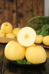 Fresh Golden Fuji Apples from Yantai with Sliced Cross-Section Showing Creamy White Flesh in Rustic Kitchen Setting