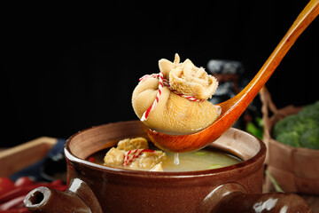 Fresh Wrapped Lamb Belly in Traditional Mongolian Hot Pot with Wooden Spoon