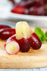 Fresh Red Grapes with Peeled Golden Flesh on Wooden Cutting Board - Healthy Organic Fruit