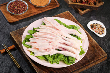 Fresh Duck Meat Slices on Lettuce with Spices and Seasonings on Wooden Board