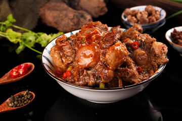 Spicy Braised Beef Oxtail Stew with Fresh Herbs and Traditional Spices in Rustic Kitchen Setting