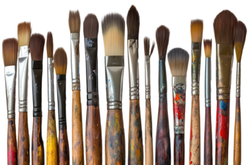 Collection of paintbrushes with residues showcasing creativity and artistry in a workspace filled with color splashes from various art projects