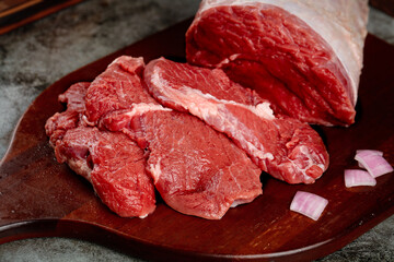 Fresh Raw Beef Steaks Cut on Wooden Board Ready for Cooking