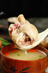 Mongolian Pork Dumpling with Fresh Filling Being Dipped in Traditional Broth - Authentic Asian...