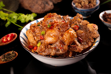 Spicy Braised Oxtail Stew with Onions and Red Chilies in Traditional Bowl
