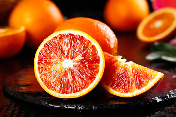 Blood Orange Tarocco Citrus Halves with Deep Red Flesh on Wooden Surface