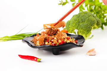 Fresh Raw Beef Tripe with Spicy Chili Peppers and Vegetables on Black Plate for Traditional Asian...