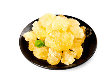 Yellow Rock Cane Sugar Crystals Candy on Black Plate Traditional Handmade Sweet Confectionery Display