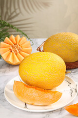 Fresh Golden Cantaloupe Melon Slices on Marble Surface with Palm Leaf Shadows