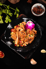 Spicy Fresh Tripe with Vegetables and Star Anise - Traditional Asian Cuisine on Black Plate
