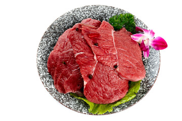 Fresh Raw Beef Slices Displayed on Decorative Plate with Garnish and Orchid Flower