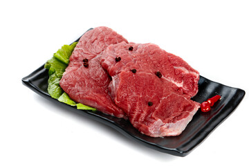 Fresh Raw Beef Steaks on Black Display Tray with Lettuce Garnish