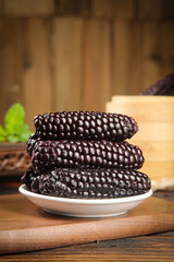 Purple Glutinous Corn from Yunnan China on Wooden Cutting Board - Traditional Asian Food Ingredient