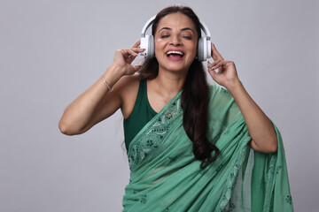 Happy Woman Enjoying Music While Wearing Headphones