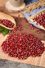 Red Adzuki Beans from Guizhou China on Bamboo Mat with Traditional Farming Tools and Grain Stalks