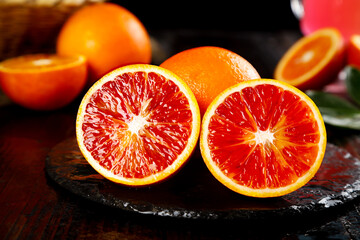 Fresh Blood Orange Slices Tarocco Variety from Sichuan China on Dark Slate Board