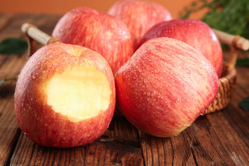 Fresh Red Fuji Apples from Shandong Luochuan - Premium Quality Fruit with Water Droplets in Wicker Basket on Wooden Table
