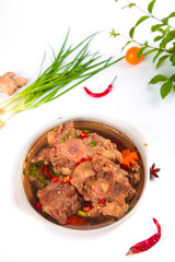 Spicy Oxtail Stew with Bone Marrow and Fresh Herbs on White Background