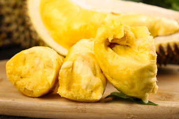 Fresh Golden Durian Fruit Flesh Segments on Wooden Board - Exotic Tropical Asian Food