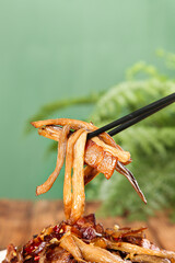 Sautéed Eggplant with Dried Bacon on Chopsticks - Asian Cuisine Cooking