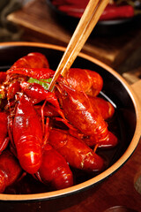 Braised Crayfish Qianjiang Xuyi Style - Delicious Chinese Seafood Dish with Chopsticks in Black Bowl