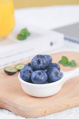 Fresh Blueberries in White Bowl on Wooden Board - Healthy Berry Breakfast Display