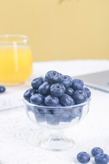 Fresh Blueberries in Glass Bowl with Orange Juice on Marble Counter - Healthy Breakfast Food Photography