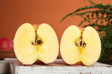 Red Striped Fuji Apples from Luochuan Shandong Province Cut in Half on Wooden Surface