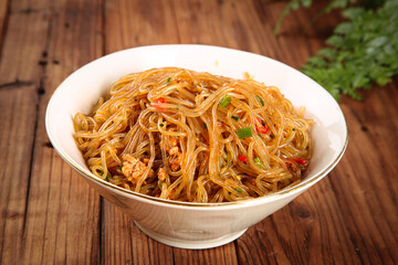 Stir-Fried Sweet Potato Vermicelli Noodles with Minced Pork in White Bowl on Wooden Table