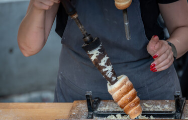 Prague,Czech Republic,August 6,2023.A stall prepares and sells the typical national dessert,chimney...