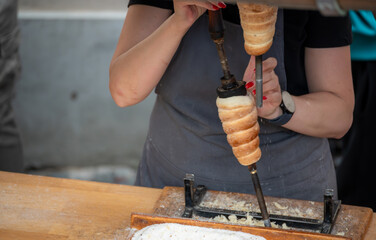 Prague,Czech Republic,August 6,2023.A stall prepares and sells the typical national dessert,chimney...